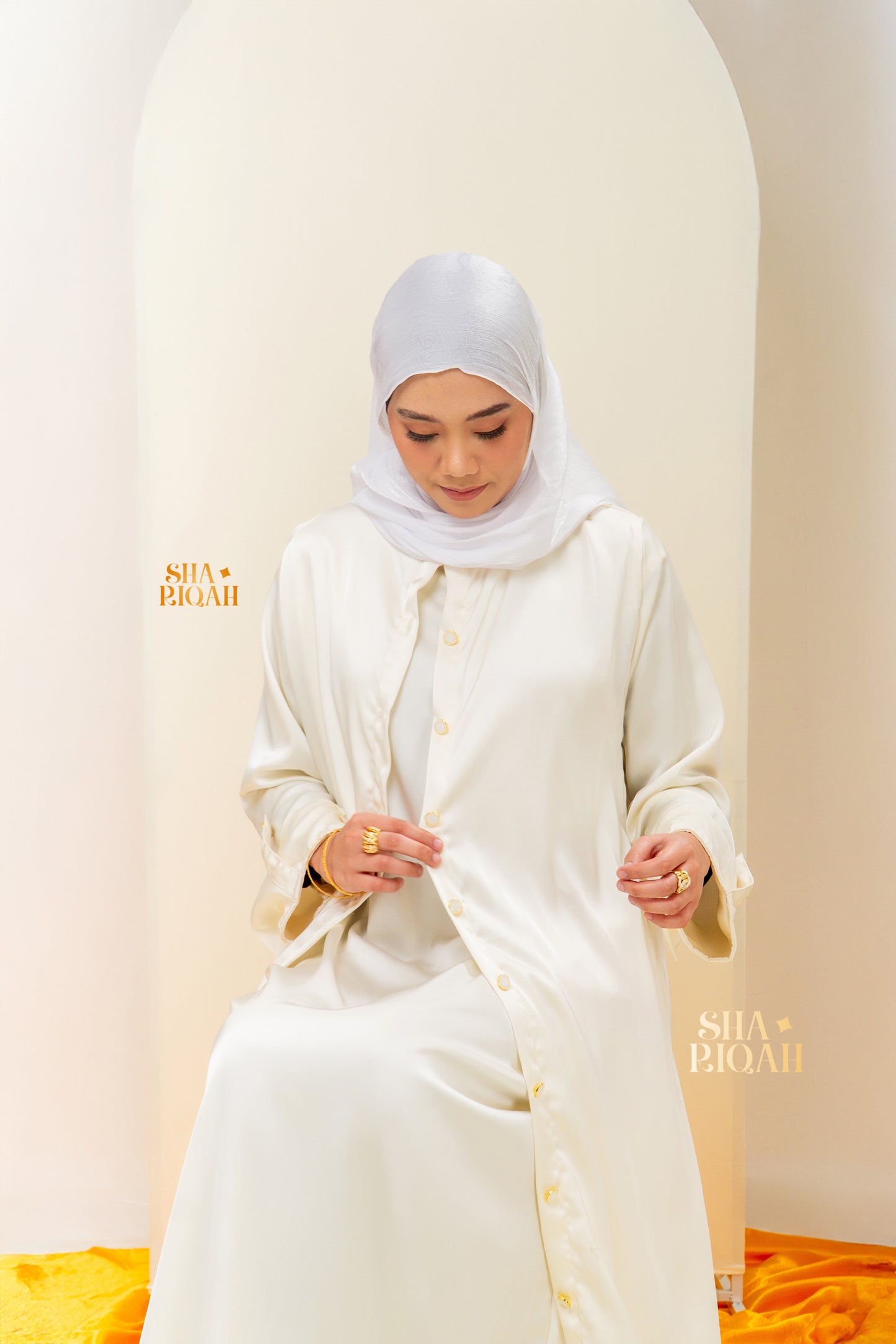 Qaaira Cardibaya in Cream White